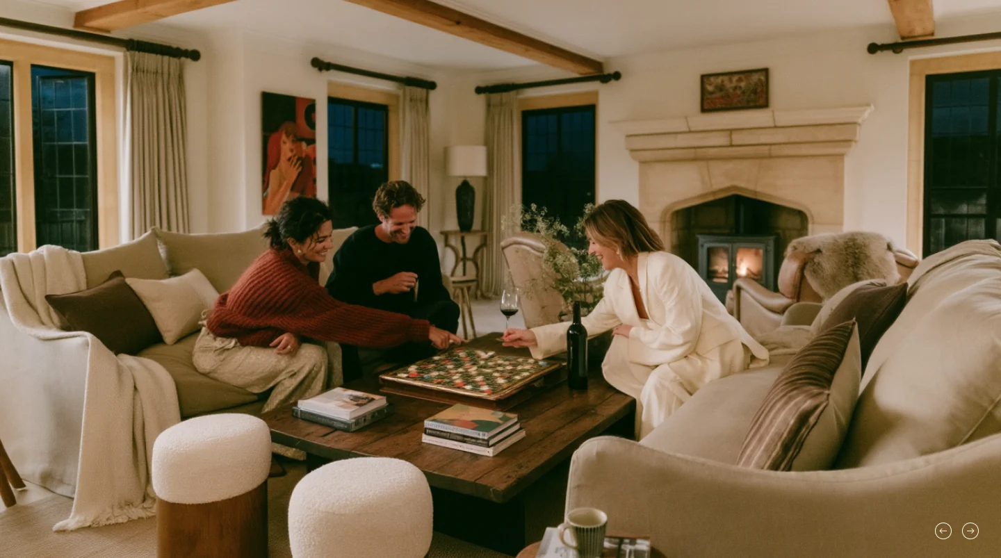 Friends playing a board game by the fire in a beamed sitting room